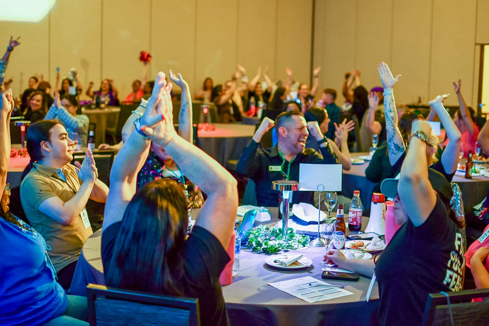 Conference attendees celebrating together at their tables